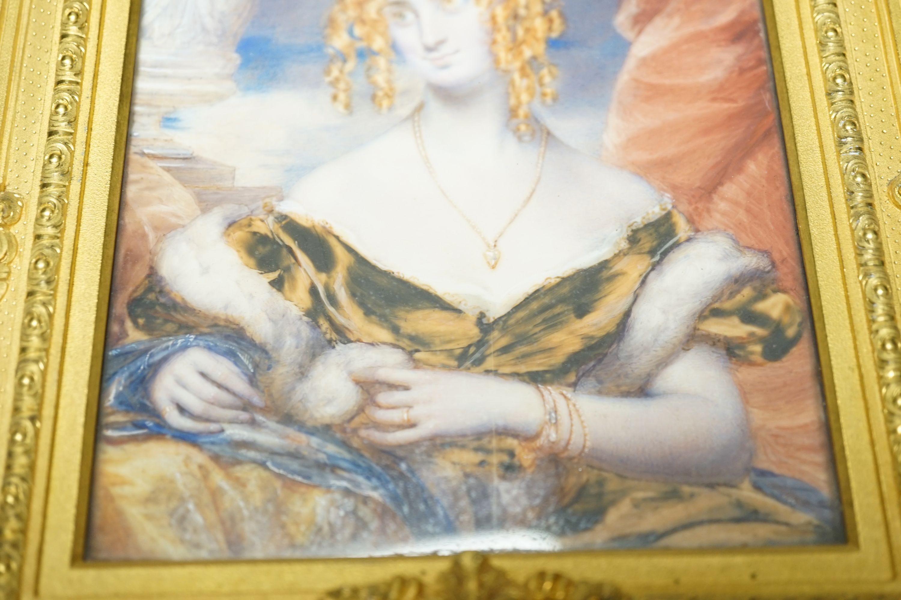19th century ormolu framed portrait miniature on ivory of a young lady with auburn hair. Length of frame - 23cm